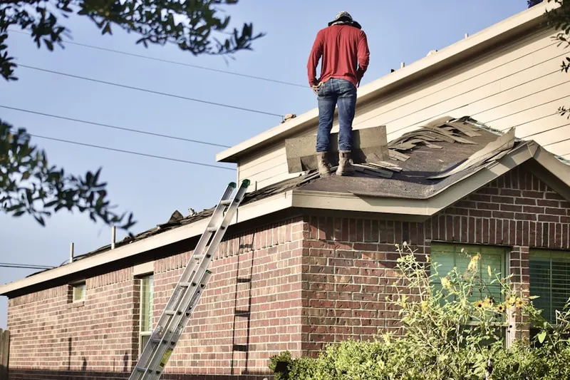 Professional roofer working on a residential roof in Lehigh Valley Junction